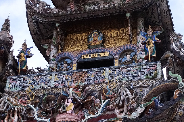 Title:『 まとめ｜リンフォック寺は、やはり異世界だった』画像説明 :*まとめ｜リンフォック寺は、やはり異世界だった*塔の高い位置に掲げられた、瓶と陶器で描かれた「リンフォック寺」のモザイク看板