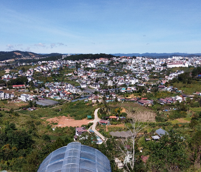Title:『 ロープウェイの乗り心地は？』画像説明 :*ロープウェイの乗り心地は？*乗り降りする時はゴンドラの動きがとてもゆっくりになるので、*楽に乗り込めます*季節は11月、日中は30度を超えますが朝夕は気持ちよく感じます*今日の天気も良くて、遠くまでダラットの街並みがきれいに見えます